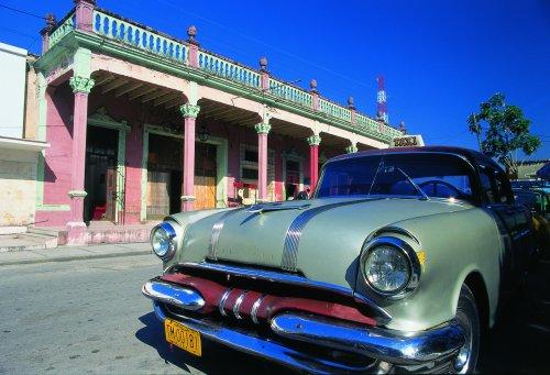 Holguin old car in front of building